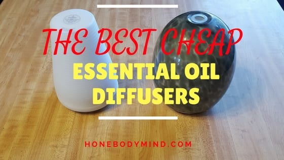 two essential oil diffusers on table