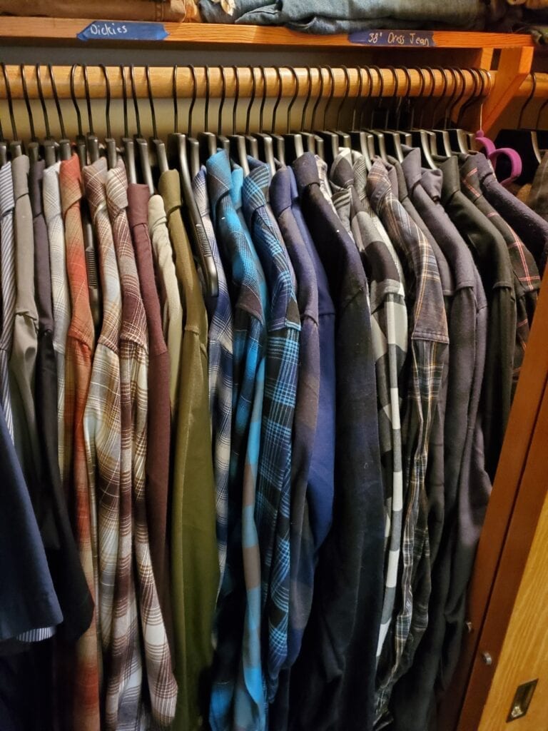 picture of closet full of dixxon flannels hung on black clothes hanger