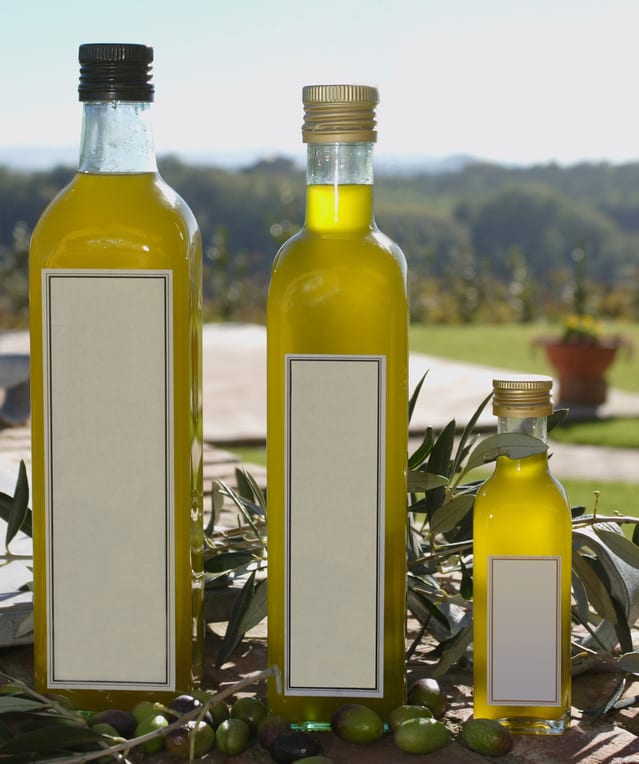 three bottles of olive oil in sun